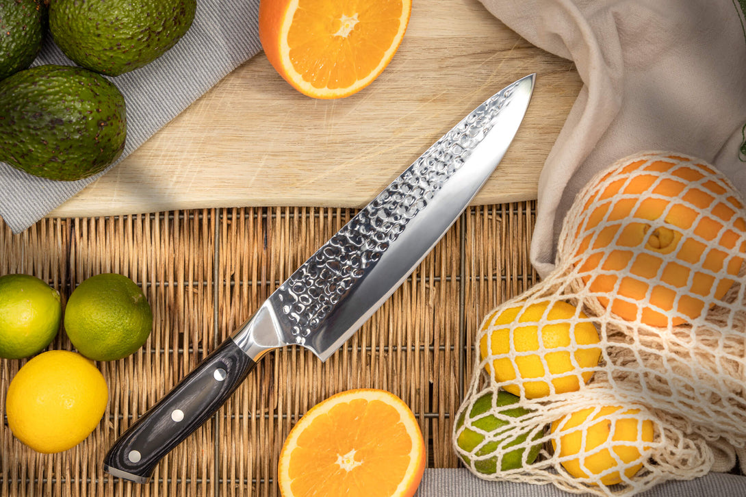 Spitfire Chef's Knife on table among fruit